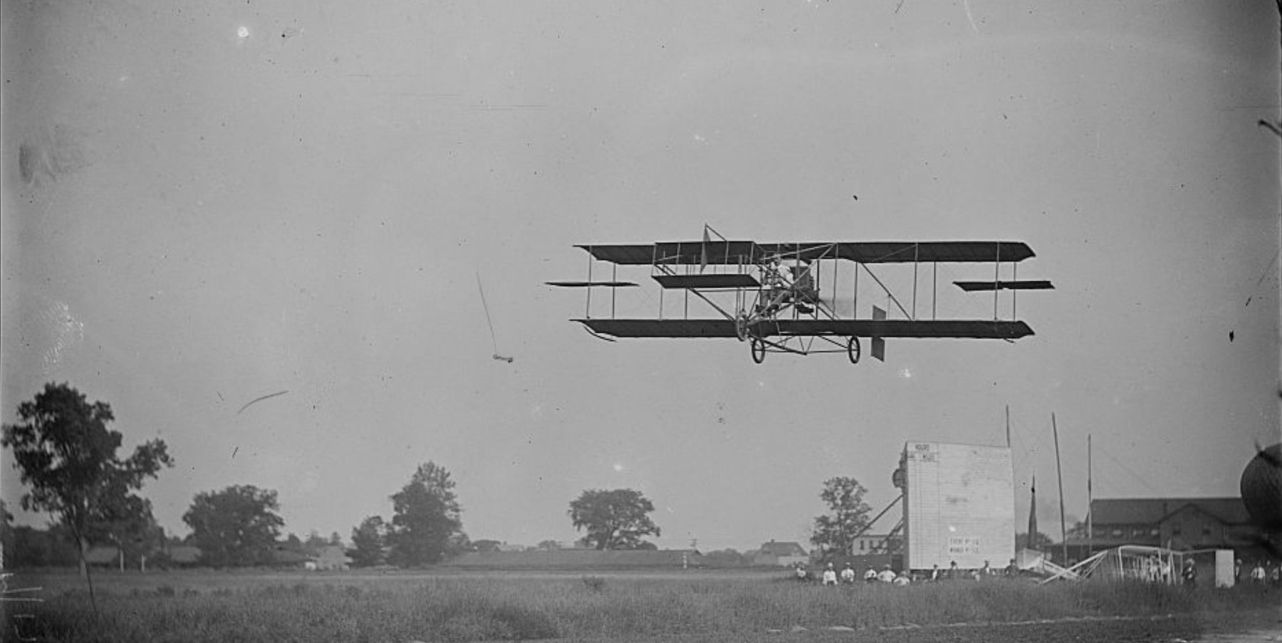 The Army and Navy Spread Their Wings - Image of a vintage airplane in flight